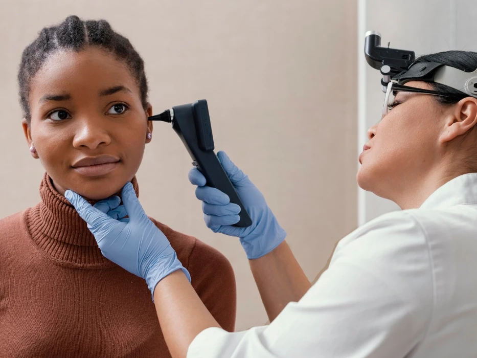 Medium shot doctor checking patient ears